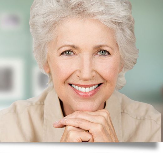 Confident senior woman smiling after dental implant treatment